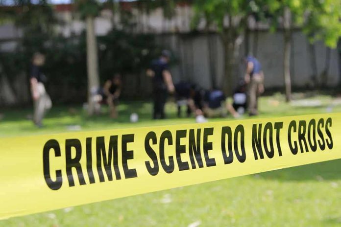 Yellow crime scene tape blocking grassy area.