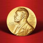 Gold Nobel Prize medal on red background