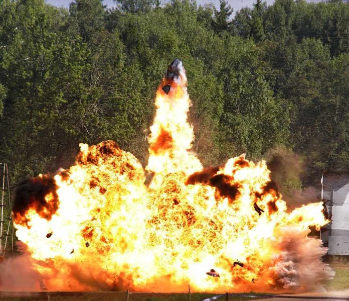 shutterstock_68754286.jpg A large explosion with flames and smoke in an outdoor setting