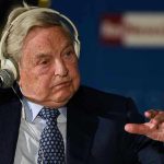 Elderly man speaks with headset and gestures.