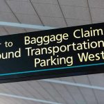 Airport sign for Baggage Claim and other destinations.