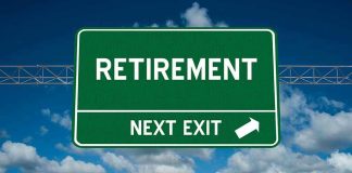 Green road sign reading retirement next exit sky background