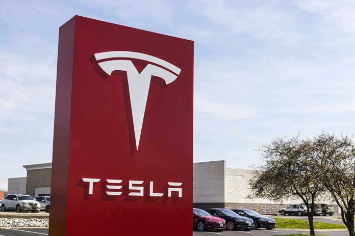 Tesla sign in front of dealership.