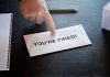 Envelope with YOURE FIRED! and pointing finger.