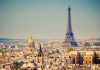 A panoramic view of Paris featuring the Eiffel Tower and a golden dome
