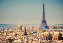 A panoramic view of Paris featuring the Eiffel Tower and a golden dome