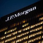 Illuminated J.P. Morgan building at night with visible office windows