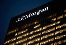 Illuminated J.P. Morgan building at night with visible office windows