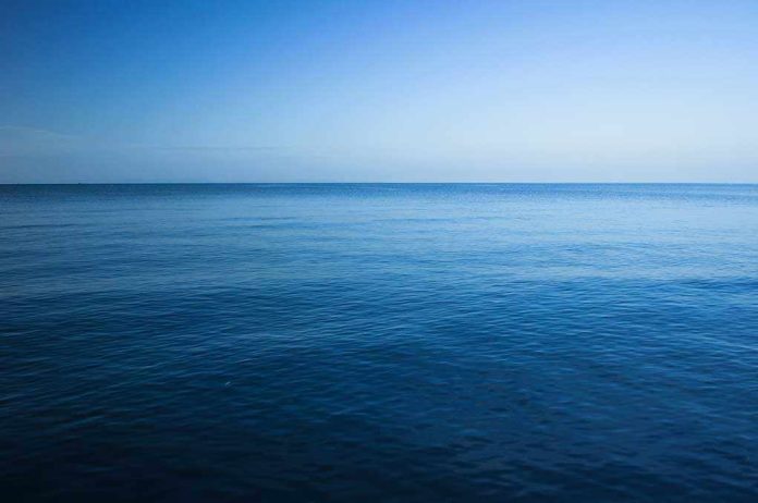 A calm ocean under a clear blue sky